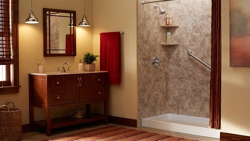 A beautiful bathroom with a craftsman style vanity and mirror and a  low-threshold shower.