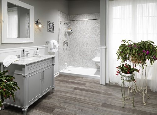 Stylish bathroom with a walk-in shower, gray hardwood floors and a gray vanity. 