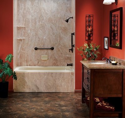 A red-walled bathroom with an acrylic tub and matching wall surrounds. 